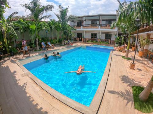 a group of people swimming in a swimming pool at Camali Hotel in Santa Marta