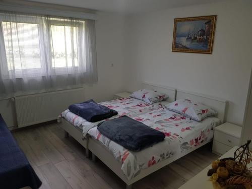 a bedroom with two beds with pillows on them at Rooms Ivan in Otočac