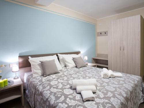 a bedroom with a large bed with two towels on it at SALA COMACINA APARTMENT NO 4-SLEEPS 10 by Italian Apartments in Sala Comacina