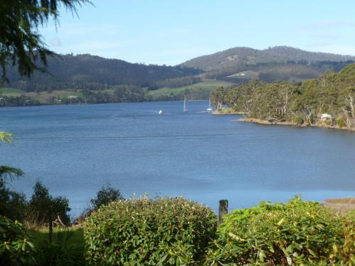 a large body of water with a boat in it at Donalea Bed and Breakfast & Riverview Apartment in Castle Forbes Bay