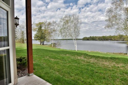 a view of a lake from the porch of a house at Unit 411A 1 Bd 1 Ba Condo Condo in Birchwood