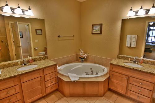 a bathroom with two sinks and a bath tub at Unit 411A 1 Bd 1 Ba Condo Condo in Birchwood
