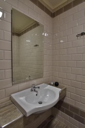 a bathroom with a sink and a mirror at Dafni Plus Hotel in Leptokaria