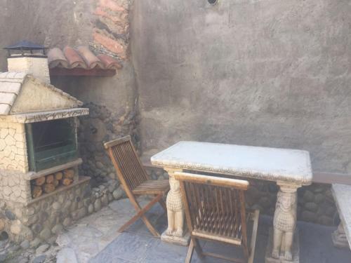 a table and two chairs next to a stone oven at CAL PINTOR in Ibars de Noguera