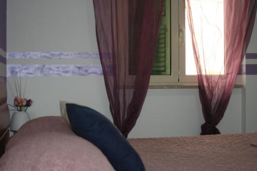Ένα ή περισσότερα κρεβάτια σε δωμάτιο στο I Villini Affittacamere
