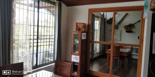 a room with a mirror and a table and a desk at Coorg North Breeze Homestay in Madikeri