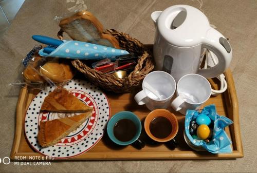 a tray with a tea pot and a plate of food at La Stanza di Rachele in Naples