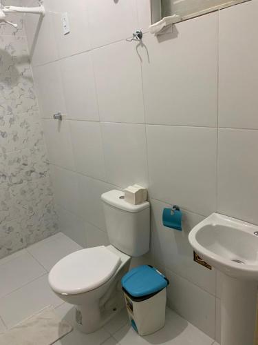 a white bathroom with a toilet and a sink at CP Hotel Economic in Natal