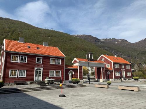 a group of buildings with mountains in the background at Høyanger 3 roms leilighet in Høyanger