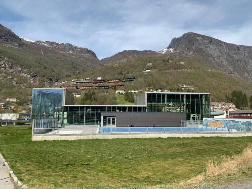 a large building in front of a mountain at Høyanger 3 roms leilighet in Høyanger