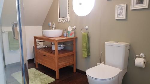 une salle de bain avec un lavabo et des toilettes dans l'établissement Sunrise Cottage, à Mégrit