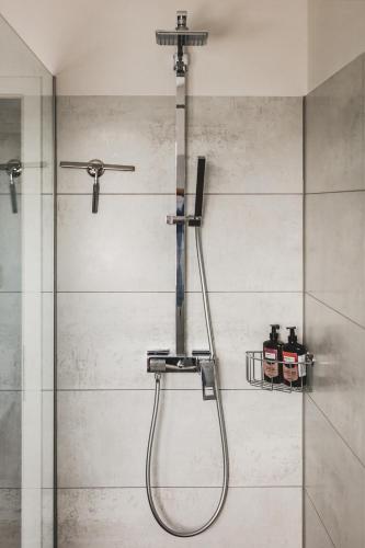 a shower in a bathroom with a glass door at O-Apartment in Obernburg am Main