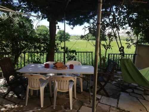 a white table and chairs under a tree at Chriselina Gottage in Paphos