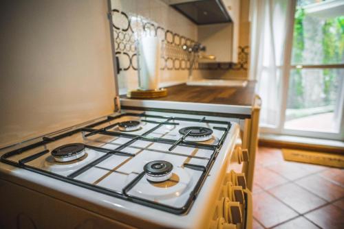 a stove top oven sitting in a kitchen at EVELYN'S HOME - Giardino&BBQ in Sestri Levante