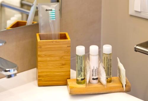 a bathroom with two toothbrushes and a wooden holder at Taormina Bedda Rooms in Taormina