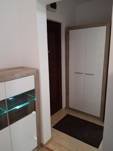 a room with a white closet and a door at Focus Home in Miercurea-Ciuc