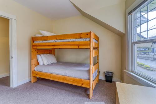 a bunk bed in a room with a window at Azusa House in Hood River
