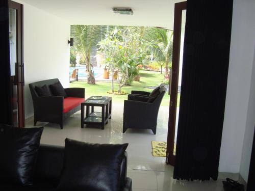 a living room with two chairs and a table at Dream Estate Resort in Senggigi 