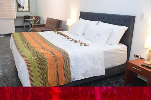 a bedroom with a bed with flowers on it at Samalá Casa Hotel in Pitalito
