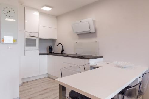 a kitchen with white cabinets and a counter top at Monte Paradiso Panorama in Pula