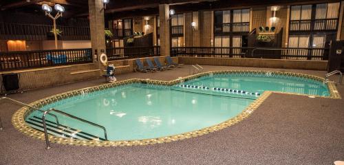 a large swimming pool in a hotel building at Ramada by Wyndham Alpena in Alpena