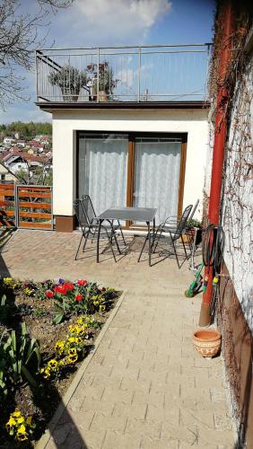 a patio with chairs and a table on a house at Nauportus in Vrhnika