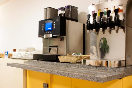 a kitchen with a coffee machine on a counter at Koopermoolen in Amsterdam