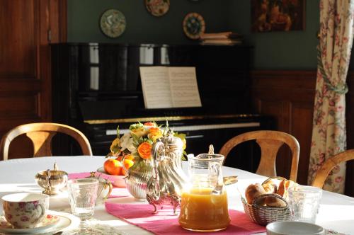 a table with a table cloth and a piano at La Liniere in Honfleur