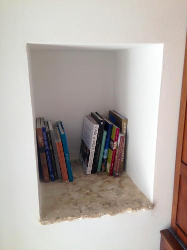 a book shelf filled with books in a wall at Masseria Ancella in Montalbano