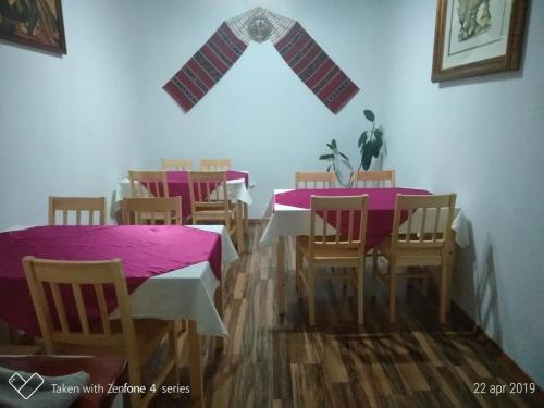 a dining room with tables and chairs with a star on the wall at Casa Suzy & Roxy in Arpaşu de Jos