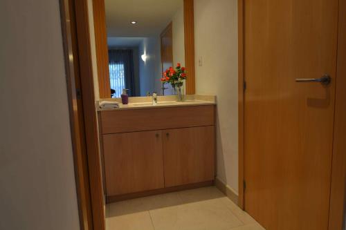 a bathroom with a sink and a mirror at Saval Spa Aqquaria Family Complex in Salou