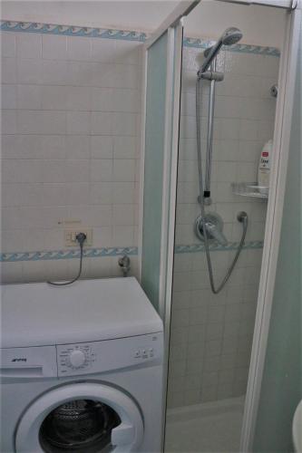 a washing machine in a bathroom with a shower at Casa Vacanza Anacapri Sunrise in Anacapri