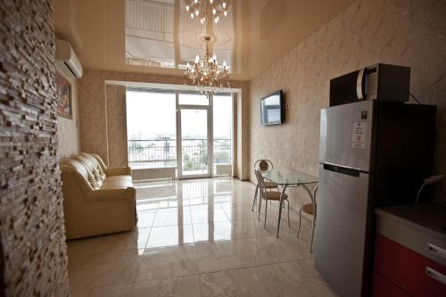 a kitchen with a refrigerator and a table in a room at DneprApartments in Dnipro