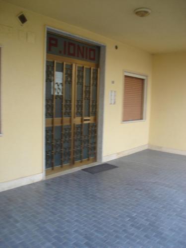 an empty building with a large glass door at Palazzo Ionio in Scalea