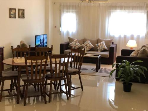 a living room with a table and chairs and a couch at El-Shorouk Housing gate2 in Cairo