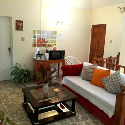 a living room with a couch and a coffee table at Paradise Inn in Port Antonio