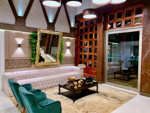 a living room with a white couch and a mirror at Hotel Staufenberg in Santa Rita