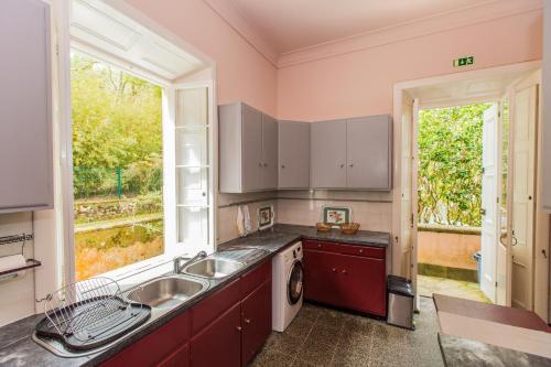 a kitchen with a sink and a window at Casa da Lagoa in Furnas