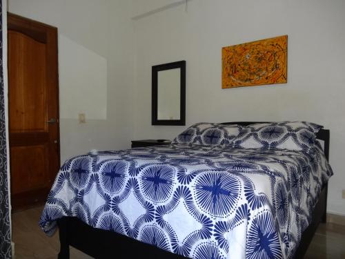 A bed or beds in a room at Conde Santome Colonial