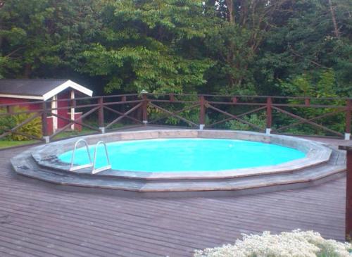 a large swimming pool on a wooden deck at Nordhagen Gate in Hjo