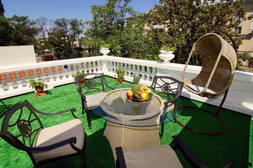 a patio with a table and chairs on the grass at Residence Odesskij Dvorik in Odesa