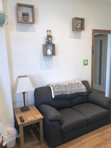 a living room with a couch and a table at Nant Apartment - Ground Floor in Menai Bridge