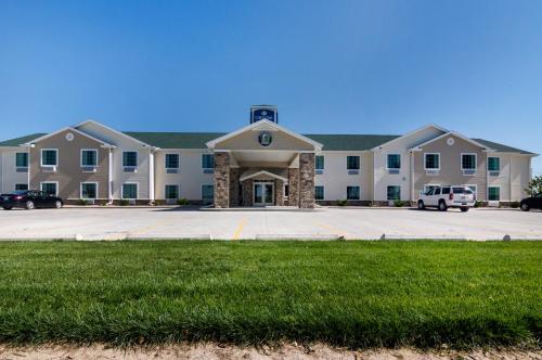 a large building with a parking lot in front of it at Cobblestone Inn & Suites - Lakin in Lakin