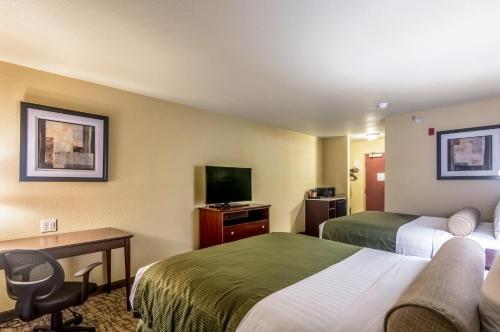 a hotel room with two beds and a television at Cobblestone Inn & Suites - Lakin in Lakin