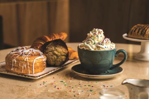 a table with a cup of coffee and a plate of pastries at W Las Vegas in Las Vegas