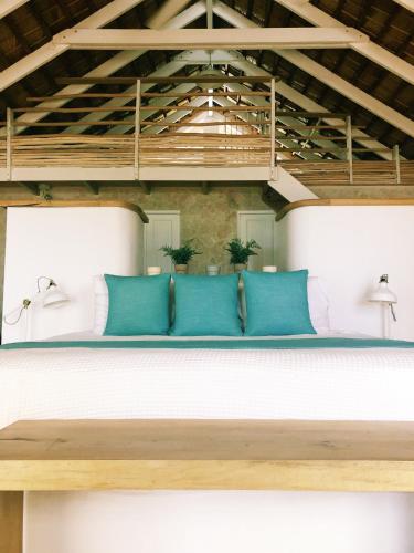 a bench with blue pillows on top of a room at El Mosquito Boutique Hotel Playa Bonita in Las Terrenas