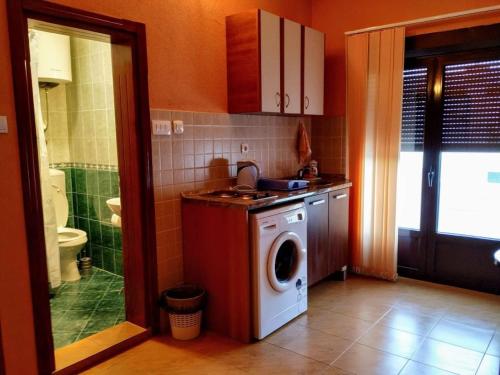 a kitchen with a washing machine and a washer at Villa Budvanka Guesthouse in Budva