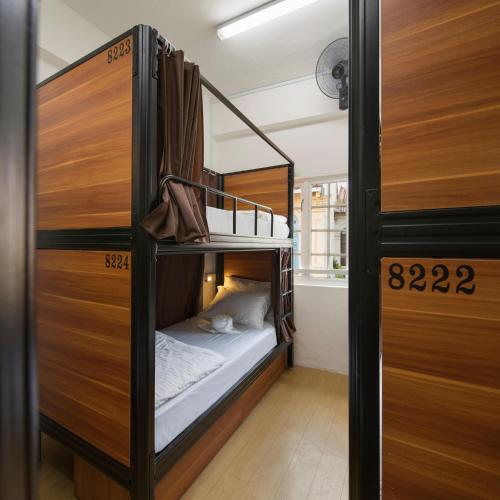 a bunk bed room with two bunk beds in it at 7 Wonders Hostel at Upper Dickson in Singapore