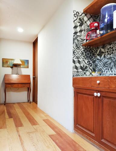 a room with a wooden cabinet and a desk at Habitaciones Coyoacan (UNAM) in Mexico City