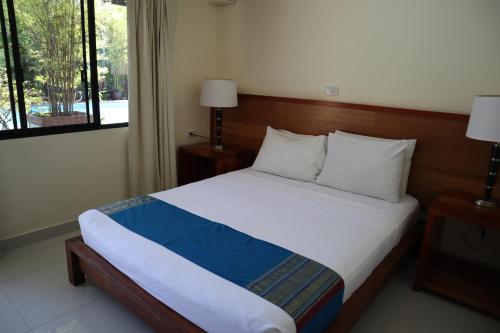 a bedroom with a bed and a window at Domicilio Lorenzo in Davao City